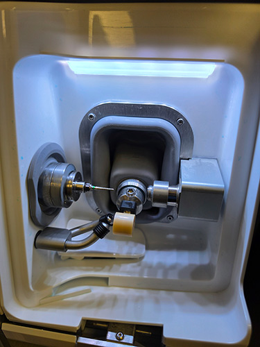 Dental milling unit carving a ceramic crown block for a same-day crown at Loo Family Dentistry